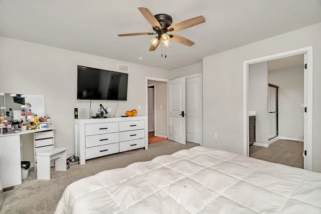 a bedroom with a bed and flat screen tv