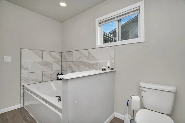a bathroom with a toilet and a shower