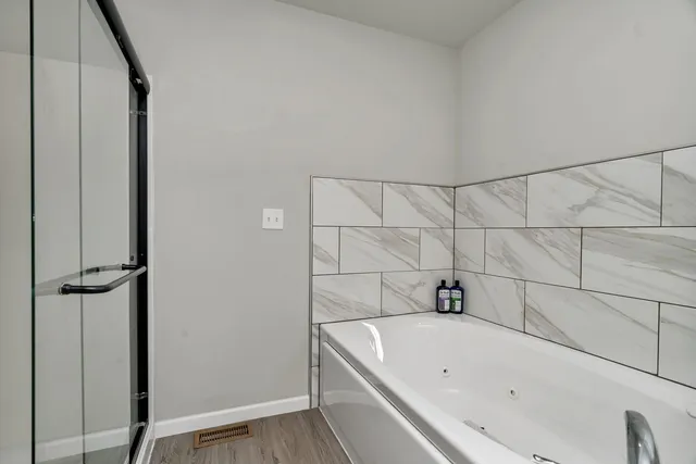 a bathroom with a tub and shower