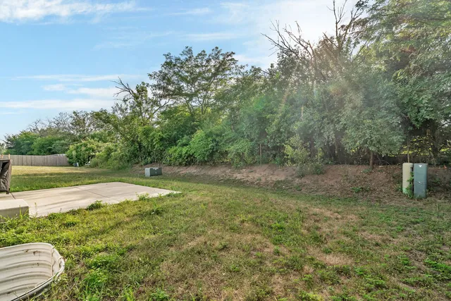a view of a field with trees in the background