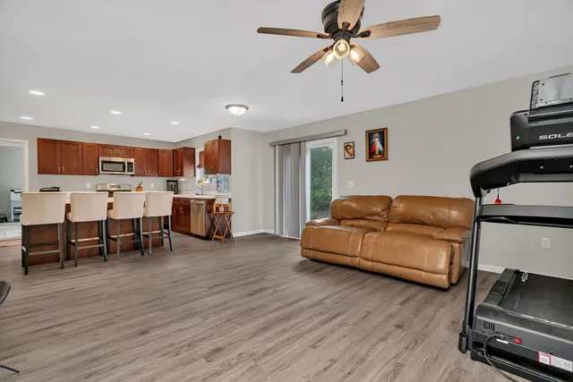 a living room with furniture and a wooden floor