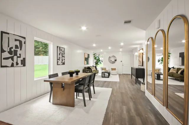 a view of a dining room with furniture window and wooden floor