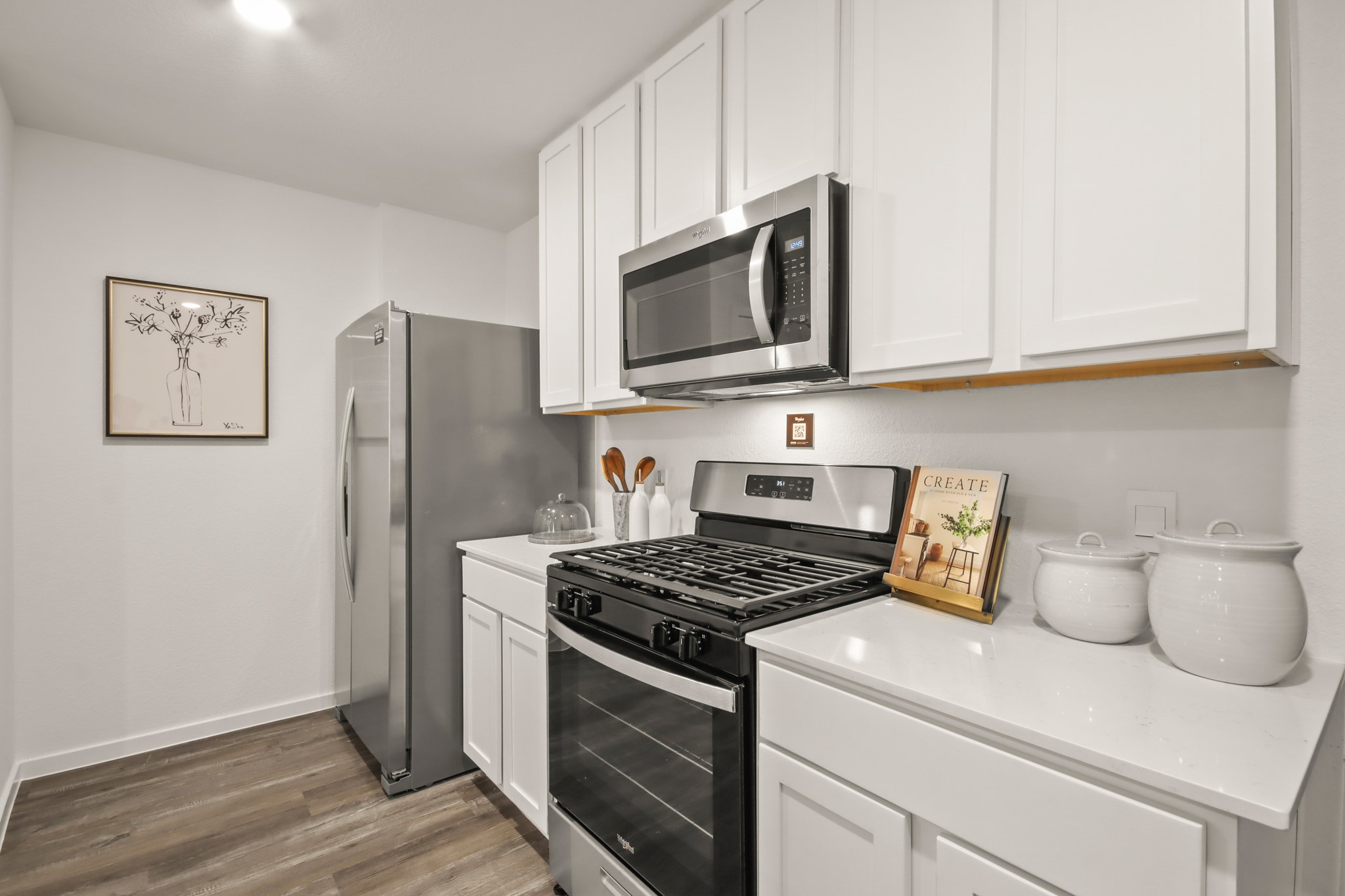 11683 Ruffian Drive Willis, TX 77318 - Photo 4 of 15 a kitchen with stainless steel appliances granite countertop white cabinets and a stove