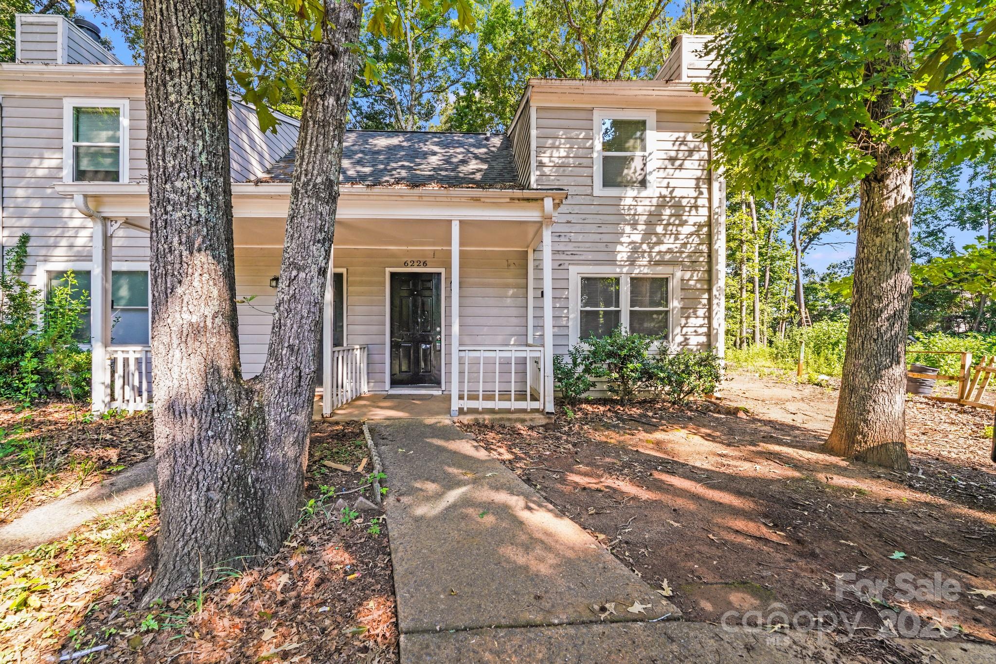 6226 Spanish Oak Road Charlotte, NC 28227 - Photo 1 of 28 front view of a house with a tree in front