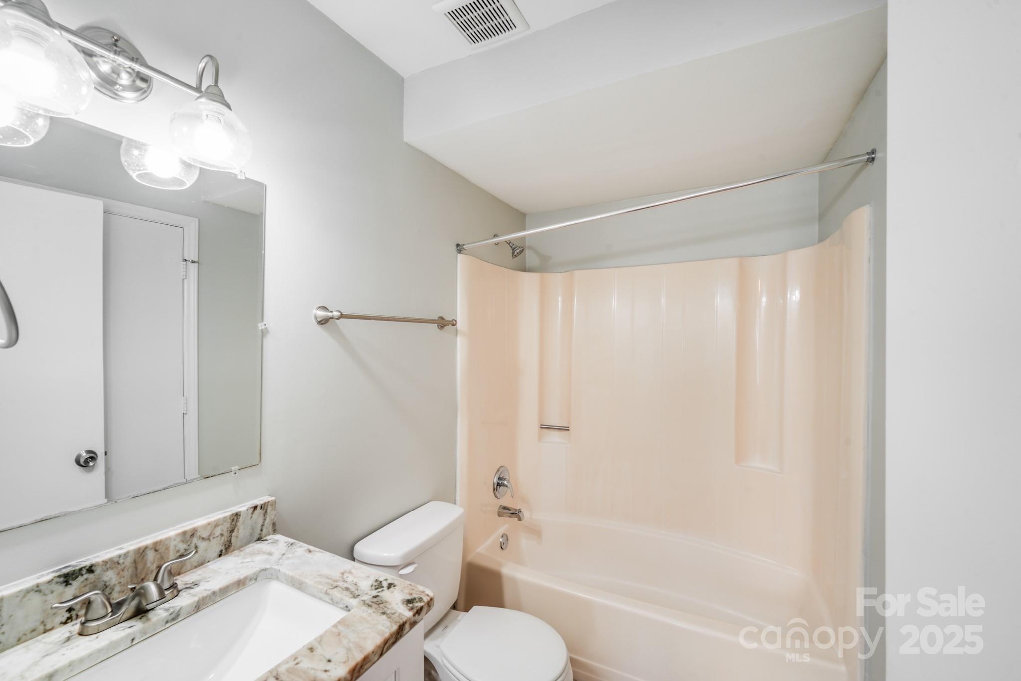 6226 Spanish Oak Road Charlotte, NC 28227 - Photo 13 of 28 a bathroom with a granite countertop sink toilet and shower