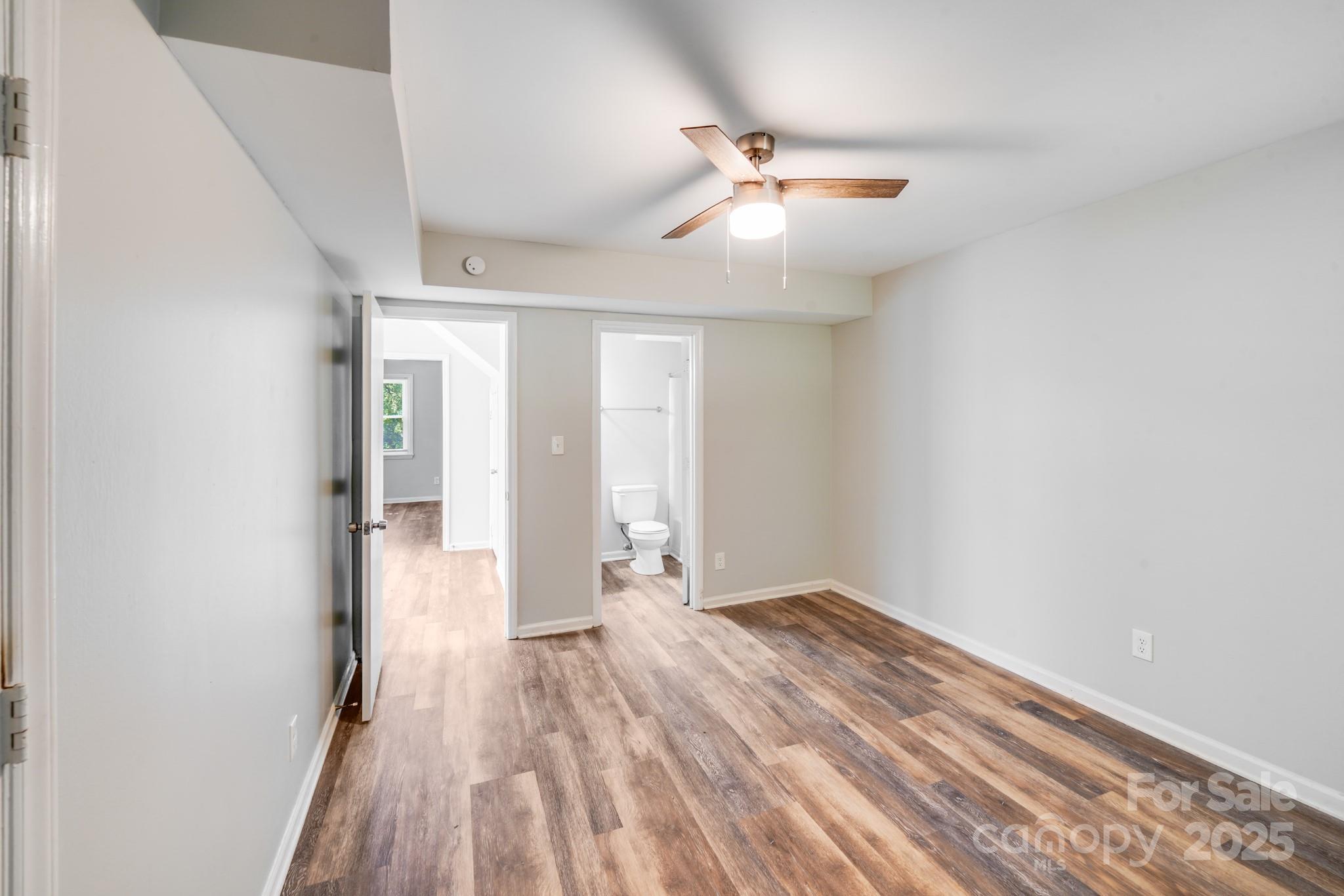 6226 Spanish Oak Road Charlotte, NC 28227 - Photo 15 of 28 wooden floor in an empty room with a window