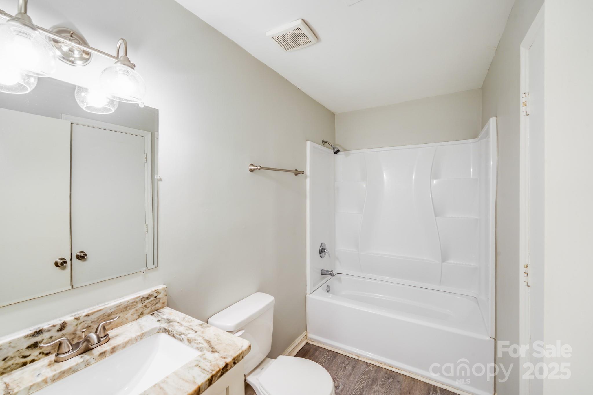 6226 Spanish Oak Road Charlotte, NC 28227 - Photo 18 of 28 a bathroom with a bathtub shower sink and toilet