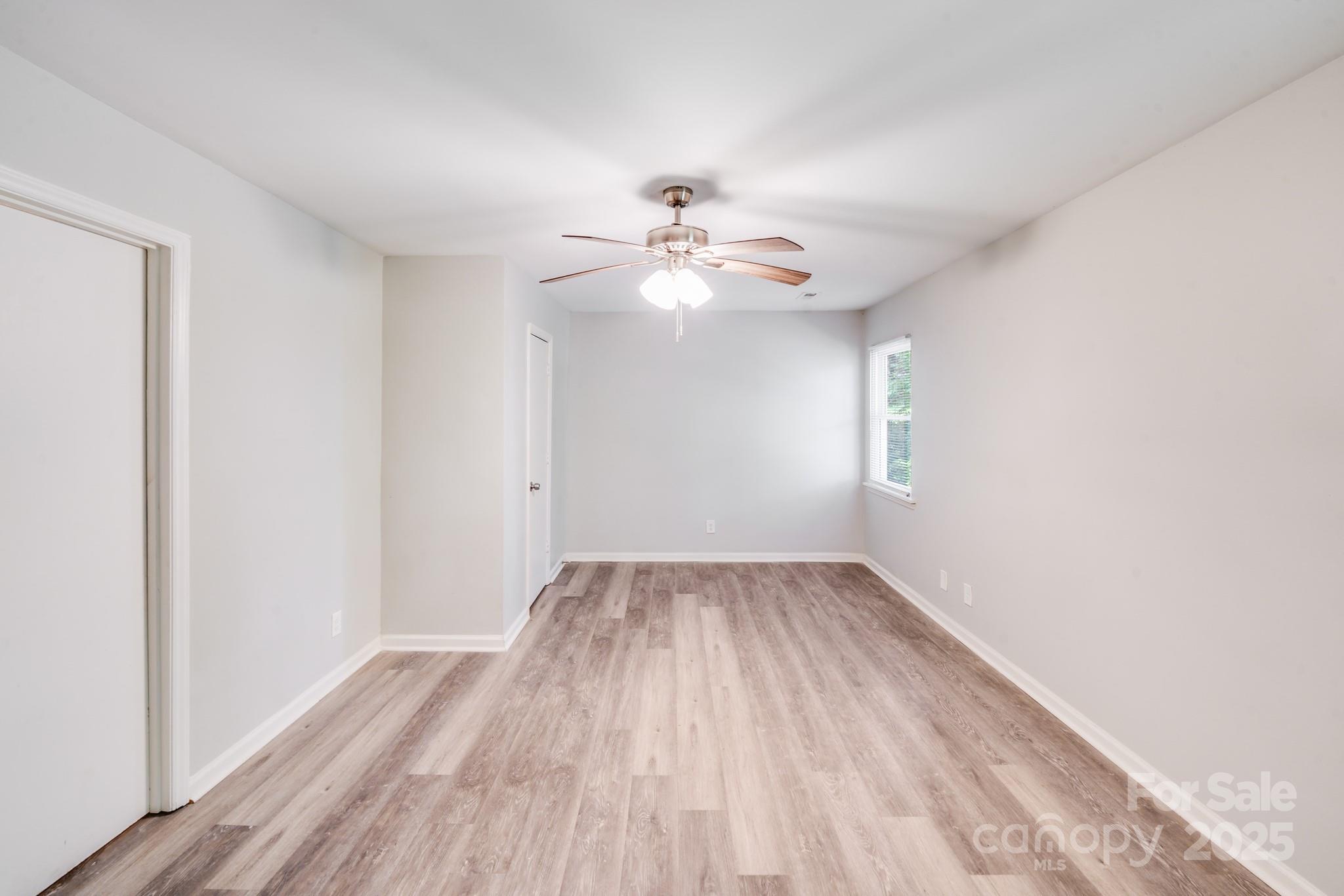 6226 Spanish Oak Road Charlotte, NC 28227 - Photo 20 of 28 wooden floor in an empty room with a window