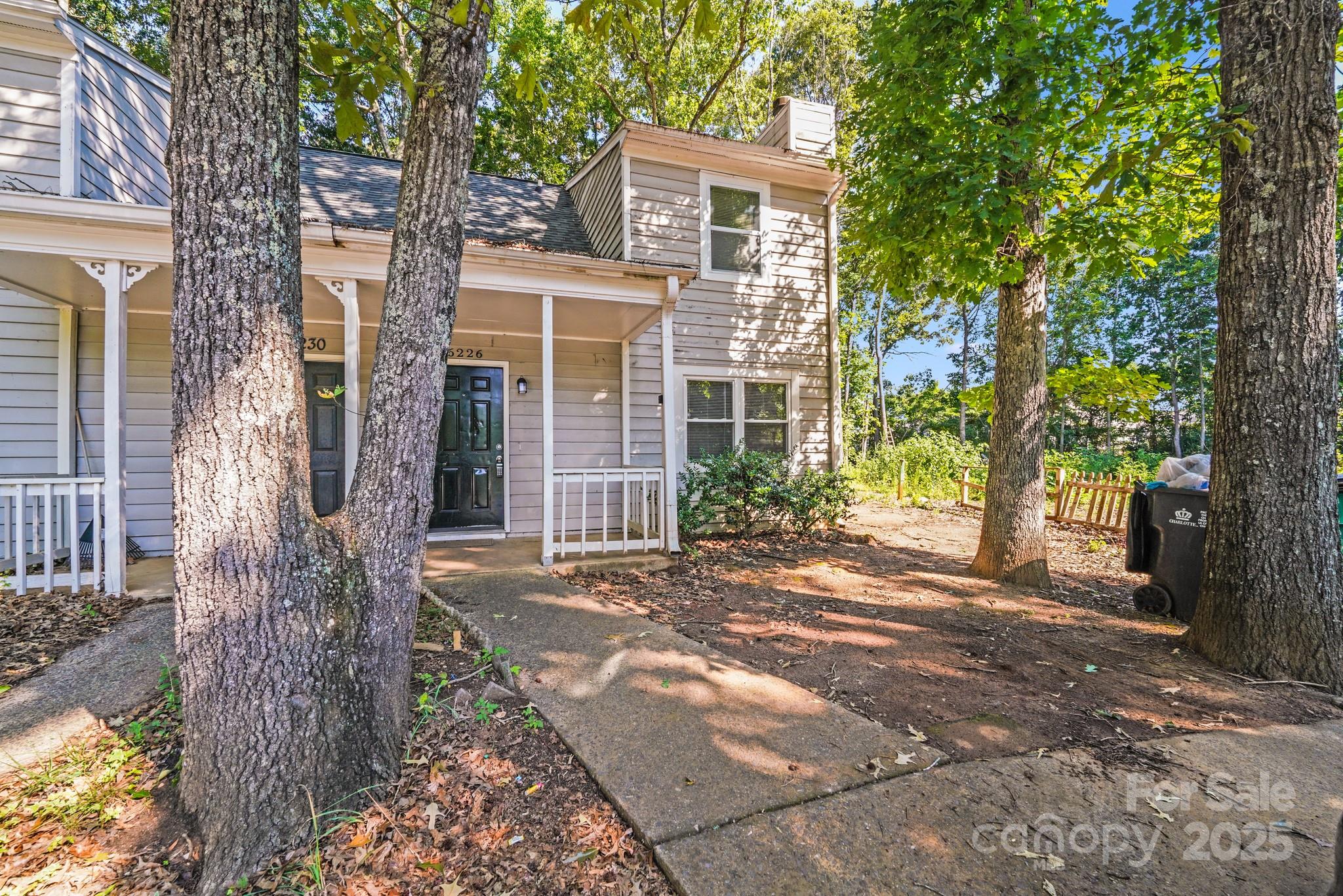 6226 Spanish Oak Road Charlotte, NC 28227 - Photo 26 of 28 front view of a house with a trees