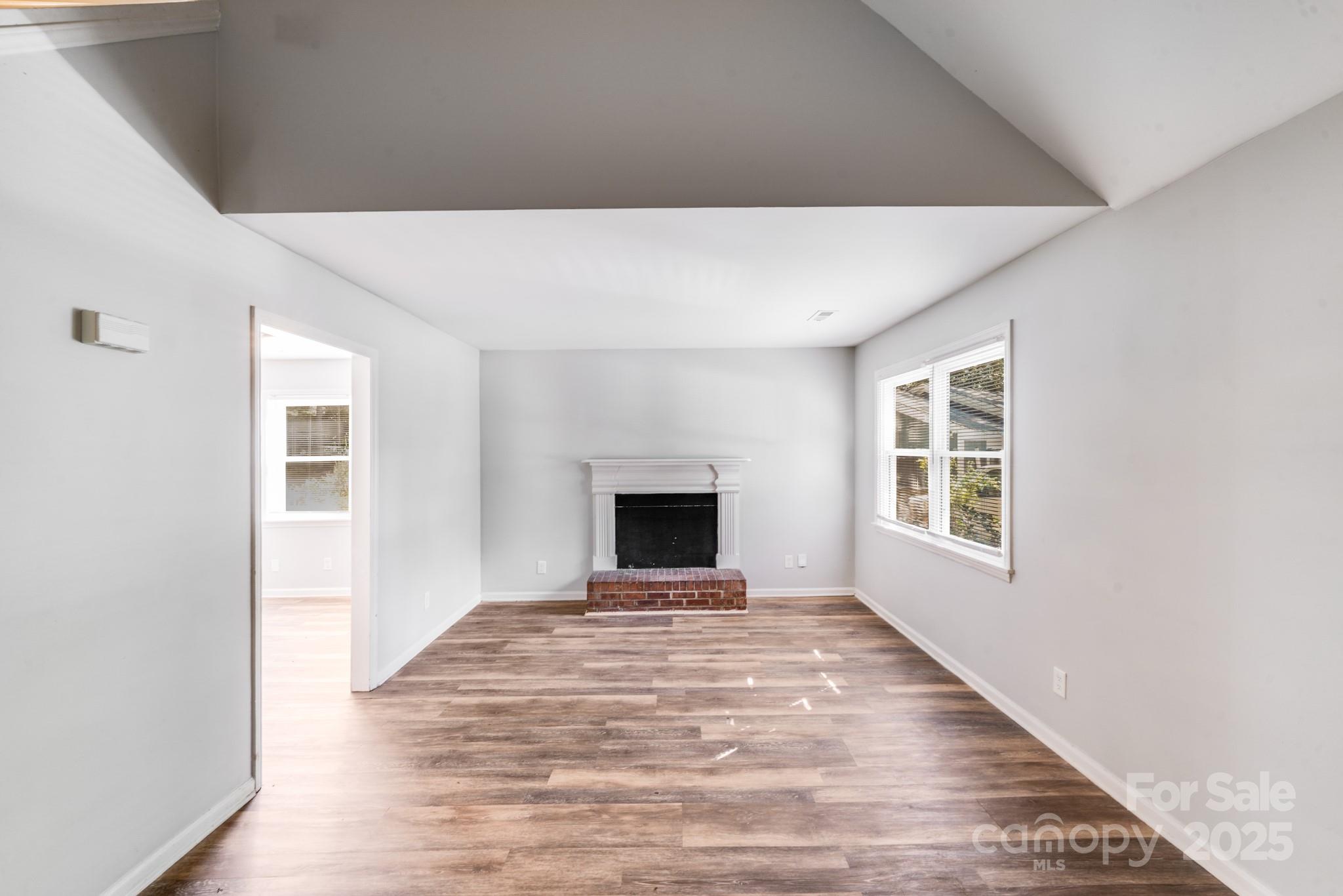 6226 Spanish Oak Road Charlotte, NC 28227 - Photo 8 of 28 a view of an empty room with window and fireplace