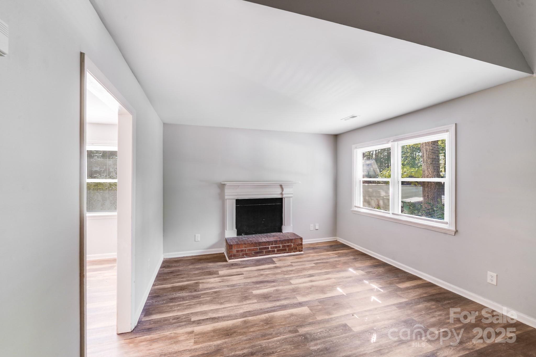 6226 Spanish Oak Road Charlotte, NC 28227 - Photo 9 of 28 a view of an empty room with window and fire place