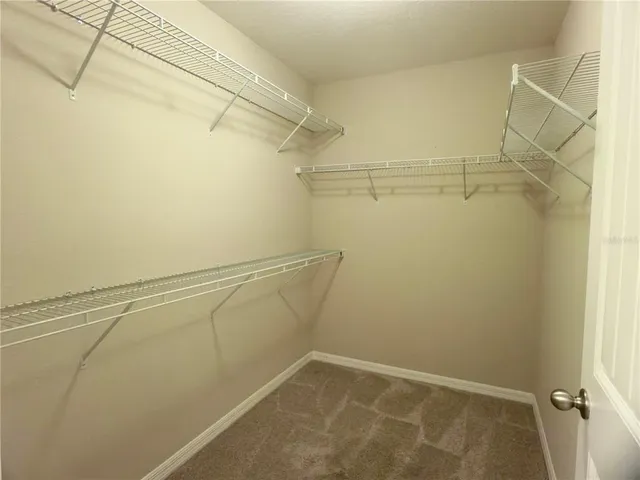 a green field with lots of trees in the background