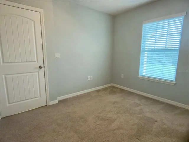 an aerial view of a house with a swimming pool