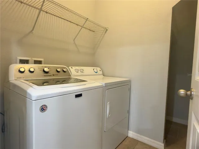 a spacious bathroom with a shower sink and mirror