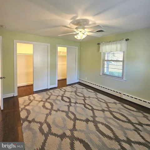 a view of a room with wooden floor and chandelier