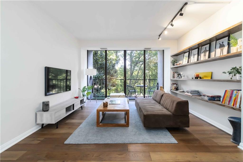 a living room with furniture large window and a flat screen tv