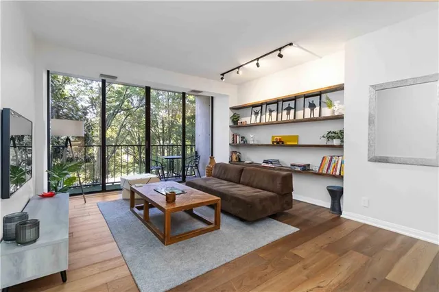 a living room with furniture and a floor to ceiling window