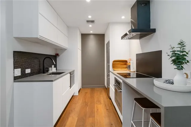 a kitchen with a sink appliances and cabinets