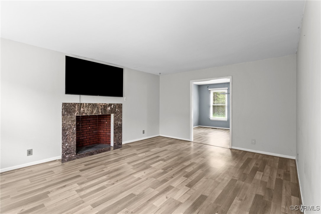 3151 Three Chopt Road Gum Spring, VA 23065 - Photo 3 of 38 a view of an empty room with wooden floor fireplace and a window