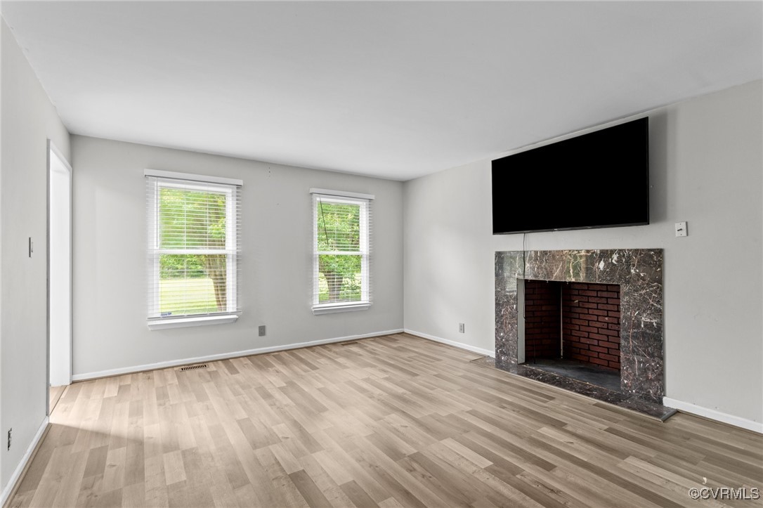 3151 Three Chopt Road Gum Spring, VA 23065 - Photo 4 of 38 a view of an empty room with a fireplace and a window