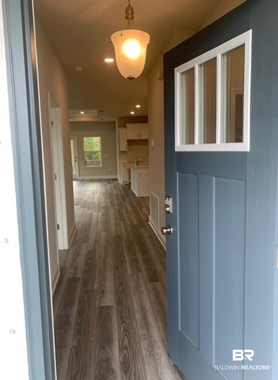 12904 Grand Rpds Road Fairhope, AL 36532 - Photo 31 of 34 Hallway featuring dark wood-type flooring
