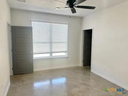 a view of an empty room with a window