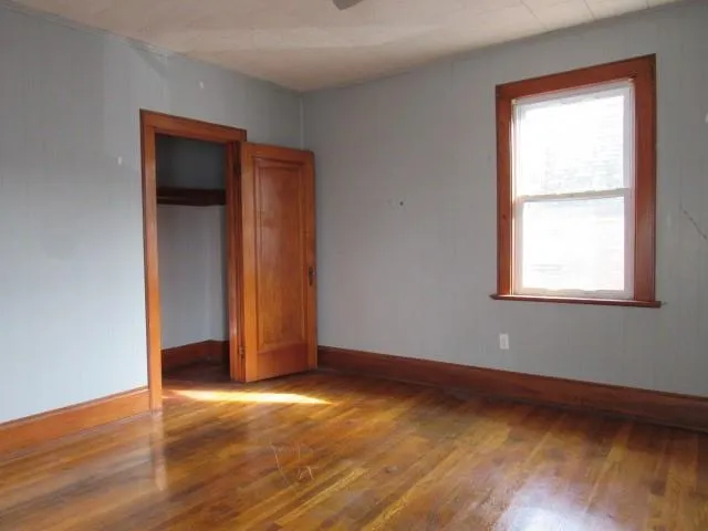 an empty room with windows and closet