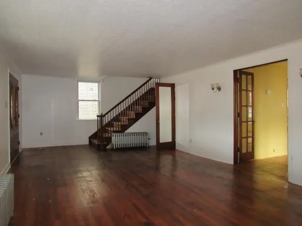 a white toilet sitting next to a window