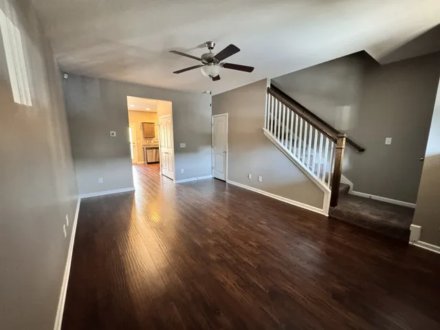 a view of empty room with wooden floor