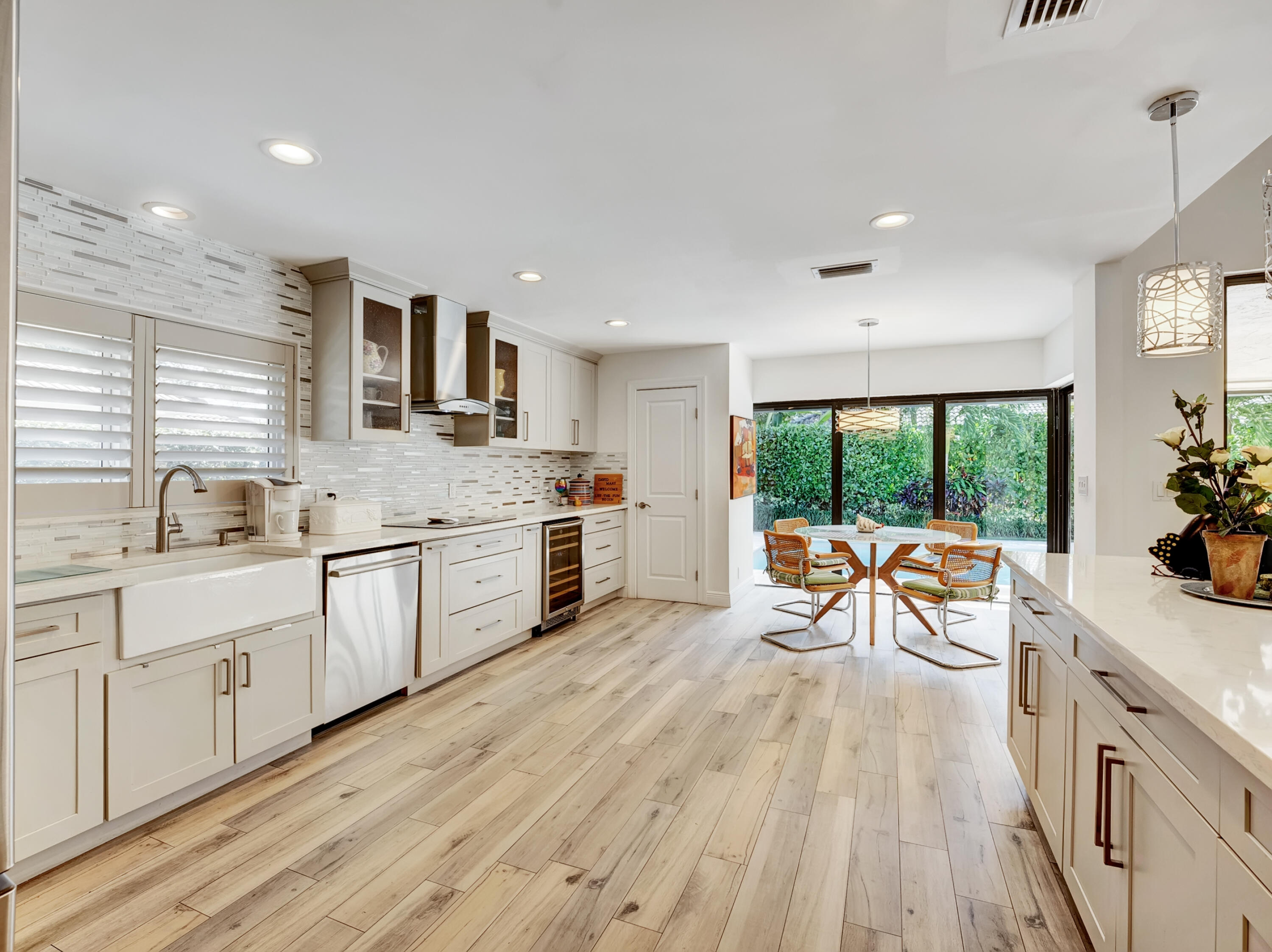 4550 White Cedar Lane Delray Beach, FL 33445 - Photo 16 of 38 a kitchen with a sink wooden floor and white appliances