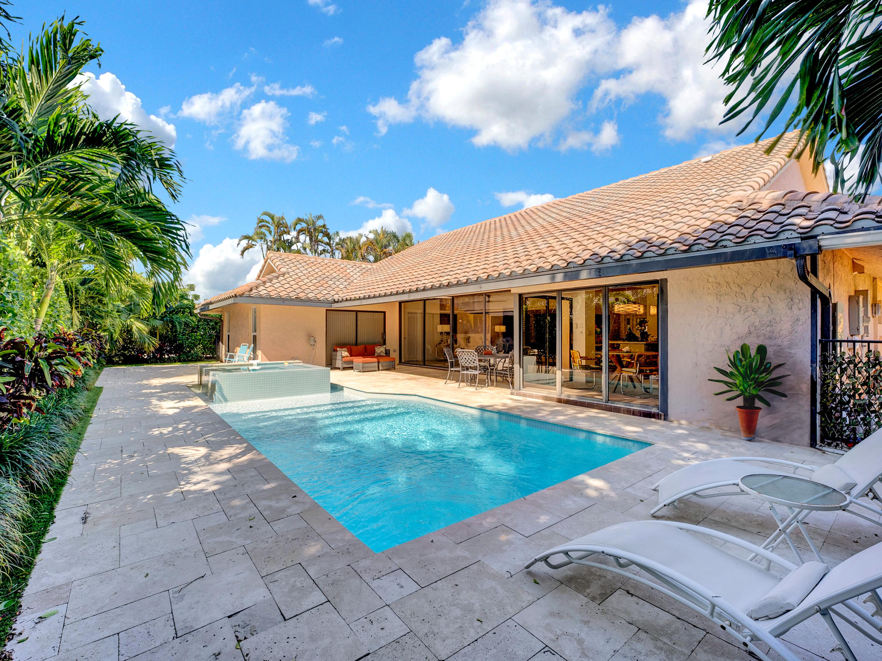 4550 White Cedar Lane Delray Beach, FL 33445 - Photo 2 of 38 a front view of a house with swimming pool having outdoor seating