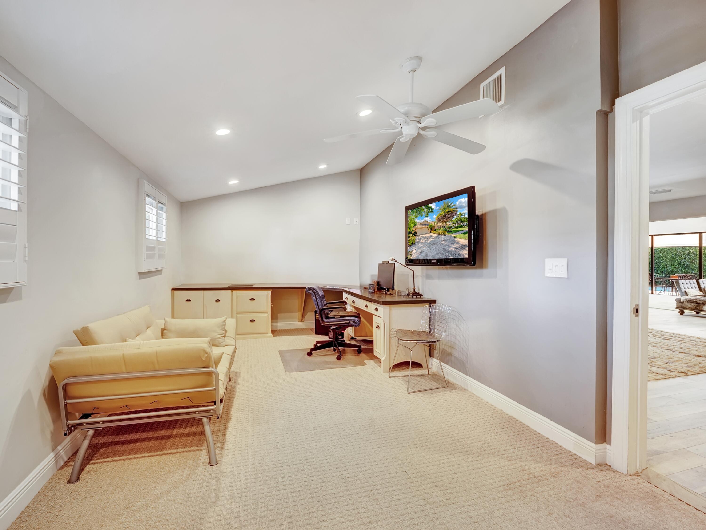 4550 White Cedar Lane Delray Beach, FL 33445 - Photo 30 of 38 a living room with furniture and a flat screen tv