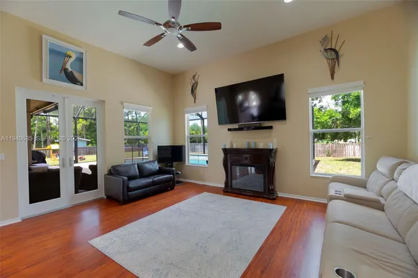 a living room with furniture a flat screen tv and a fireplace