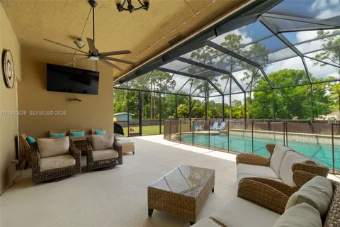a outdoor living space with furniture and a flat screen tv