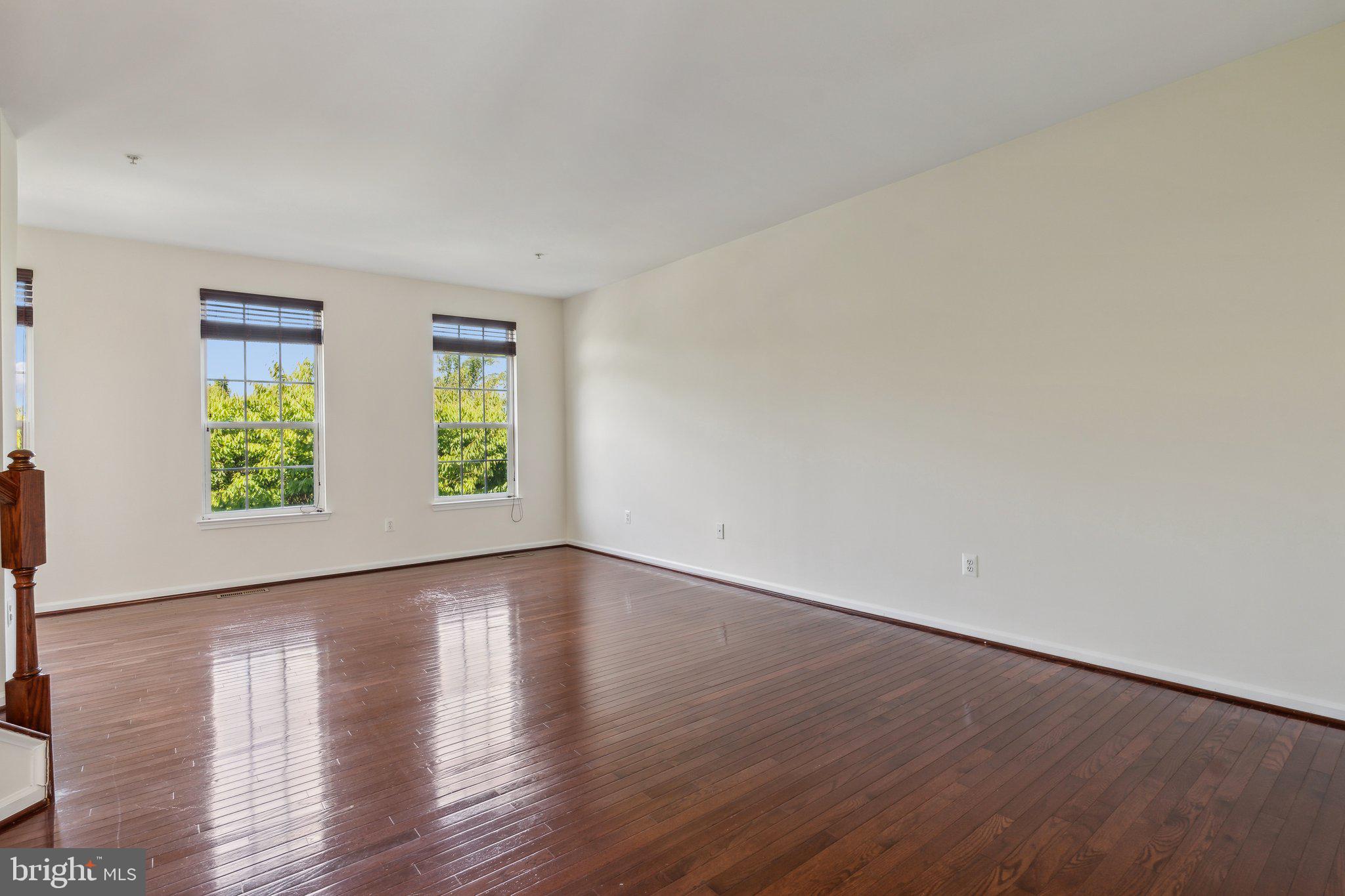 6912 Red Clay Forge, Unit 2 Elkridge, MD 21075 - Photo 11 of 46 a view of an empty room with wooden floor and a window