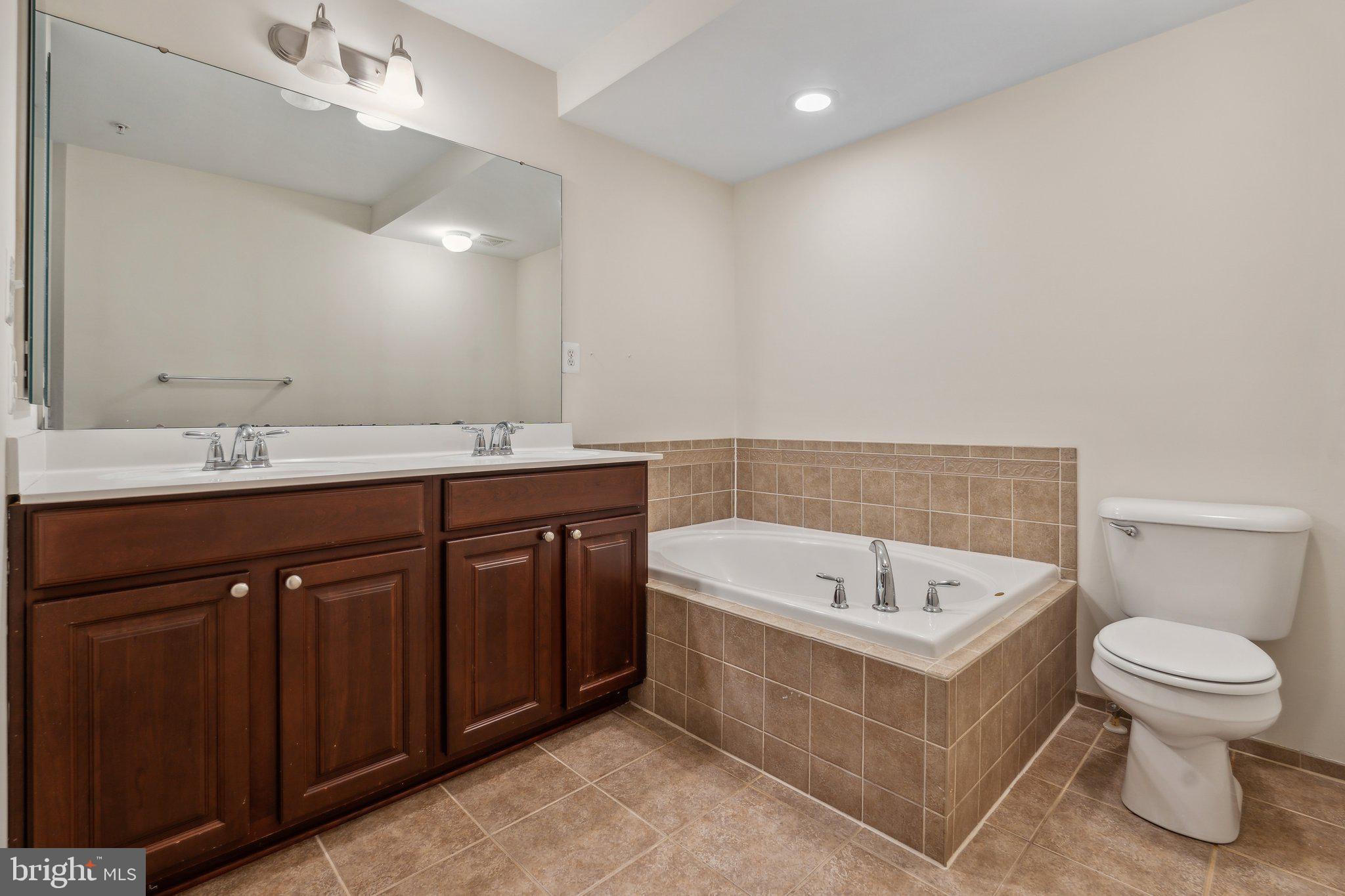6912 Red Clay Forge, Unit 2 Elkridge, MD 21075 - Photo 14 of 46 a bathroom with a sink a toilet and bathtub