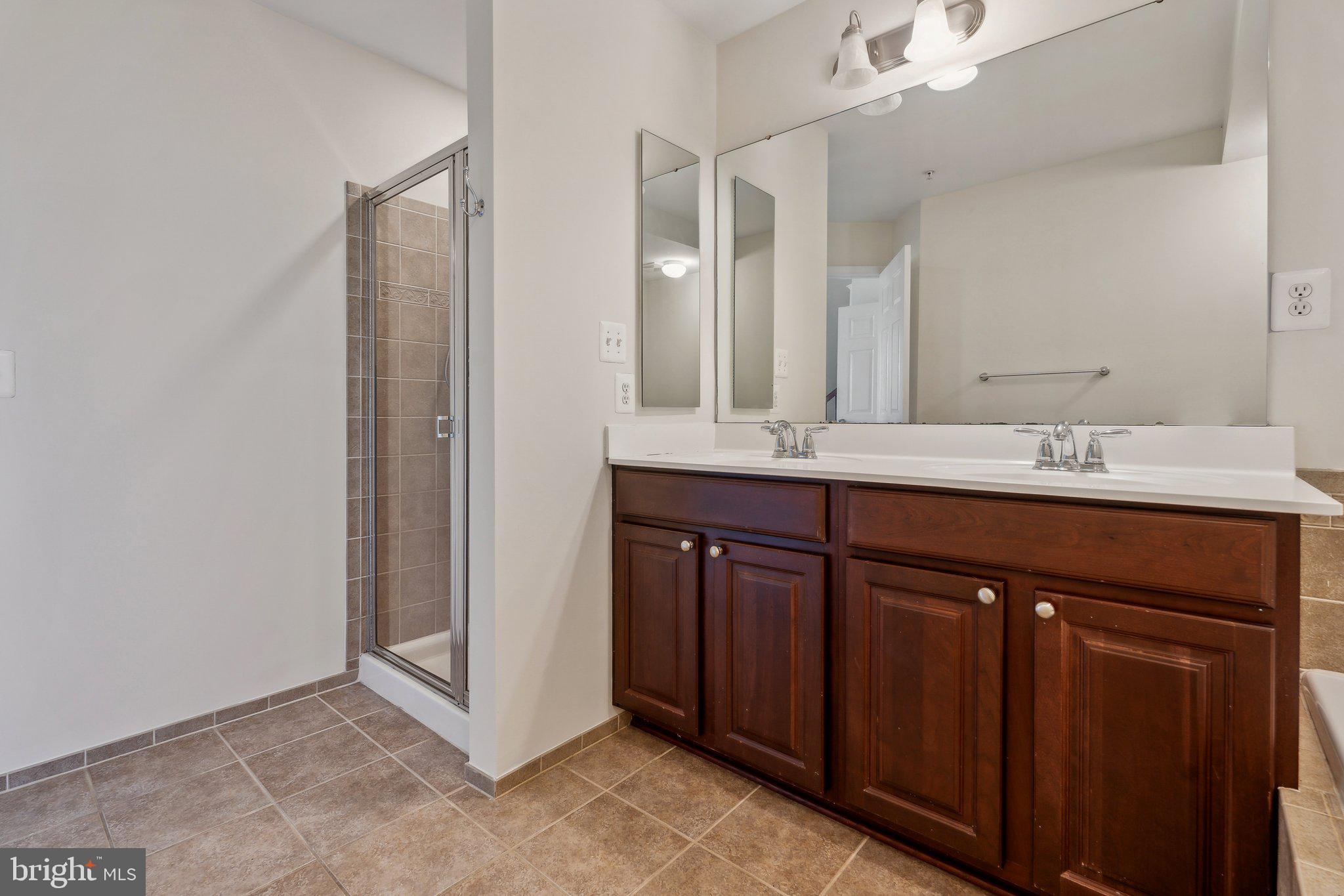 6912 Red Clay Forge, Unit 2 Elkridge, MD 21075 - Photo 15 of 46 a bathroom with a sink and a mirror