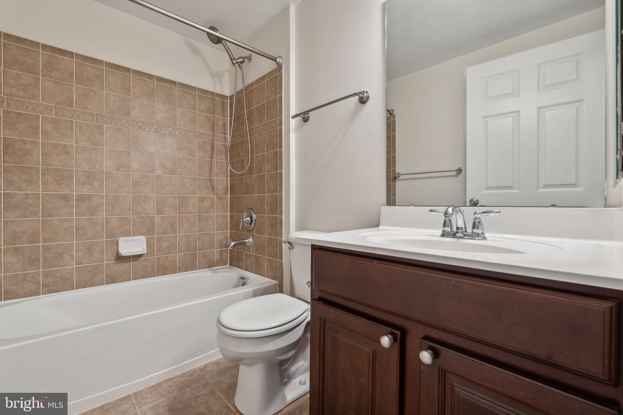 6912 Red Clay Forge, Unit 2 Elkridge, MD 21075 - Photo 19 of 46 a bathroom with a sink a toilet and shower