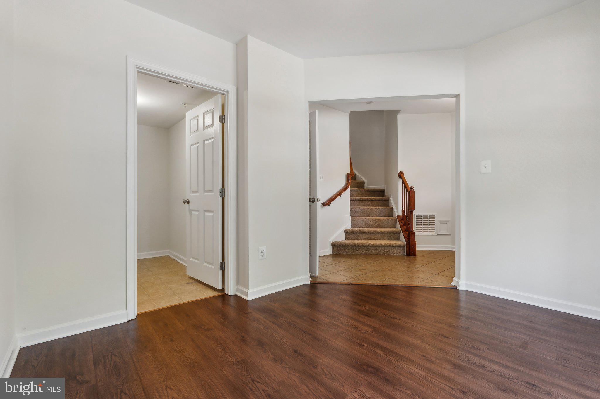 6912 Red Clay Forge, Unit 2 Elkridge, MD 21075 - Photo 24 of 46 a view of a hallway with wooden floor and stairs