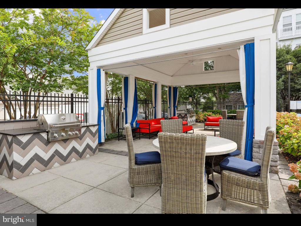 6912 Red Clay Forge, Unit 2 Elkridge, MD 21075 - Photo 34 of 46 a view of a patio with dining table and chairs