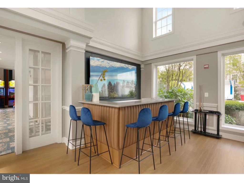 6912 Red Clay Forge, Unit 2 Elkridge, MD 21075 - Photo 43 of 46 a view of a dining room with furniture large window and wooden floor