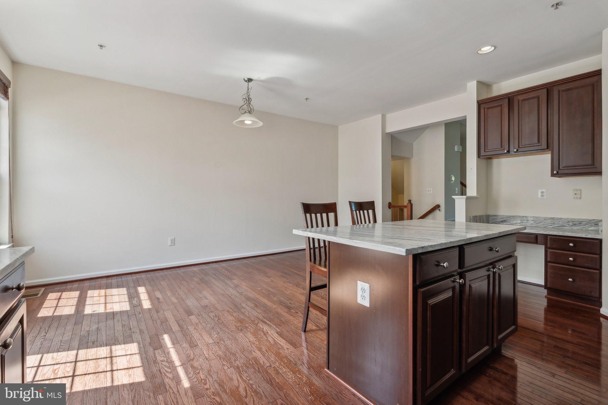 6912 Red Clay Forge, Unit 2 Elkridge, MD 21075 - Photo 8 of 46 a kitchen with granite countertop a stove a sink and a refrigerator