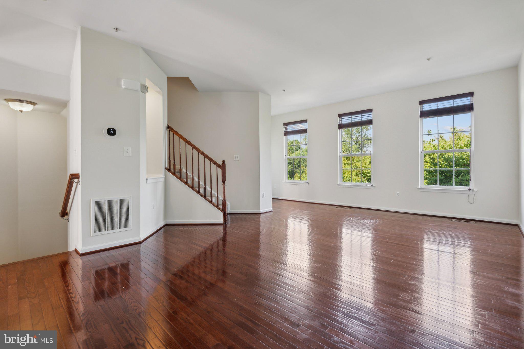 6912 Red Clay Forge, Unit 2 Elkridge, MD 21075 - Photo 9 of 46 a view of an empty room with wooden floor and a window