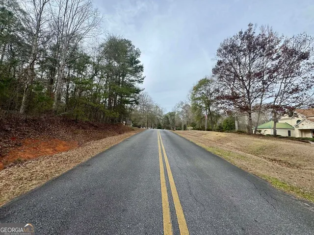 a sign that is sitting in front of a tree