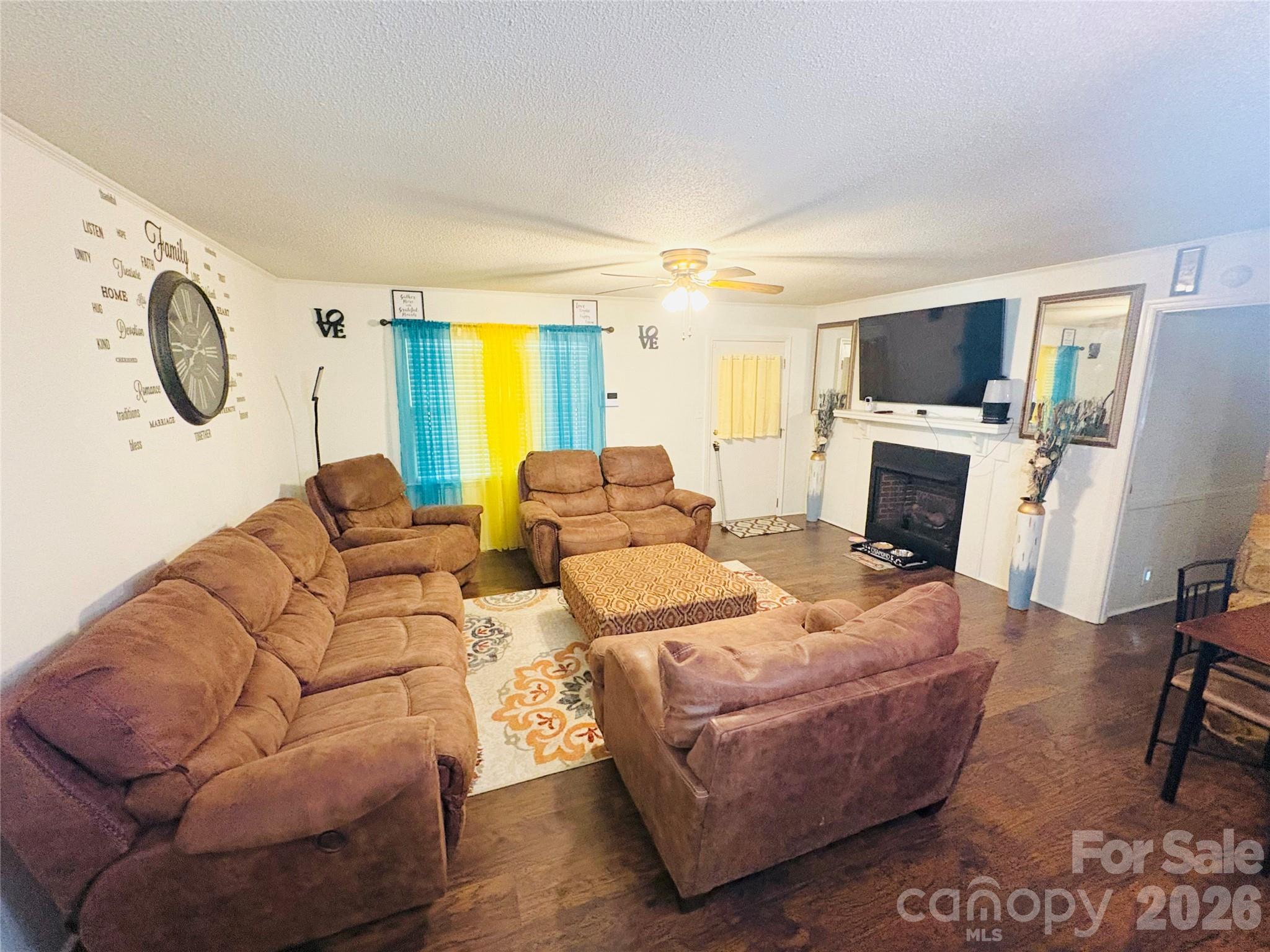 1481 Grace Avenue Lancaster, SC 29720 - Photo 7 of 22 a living room with furniture a fireplace and a flat screen tv