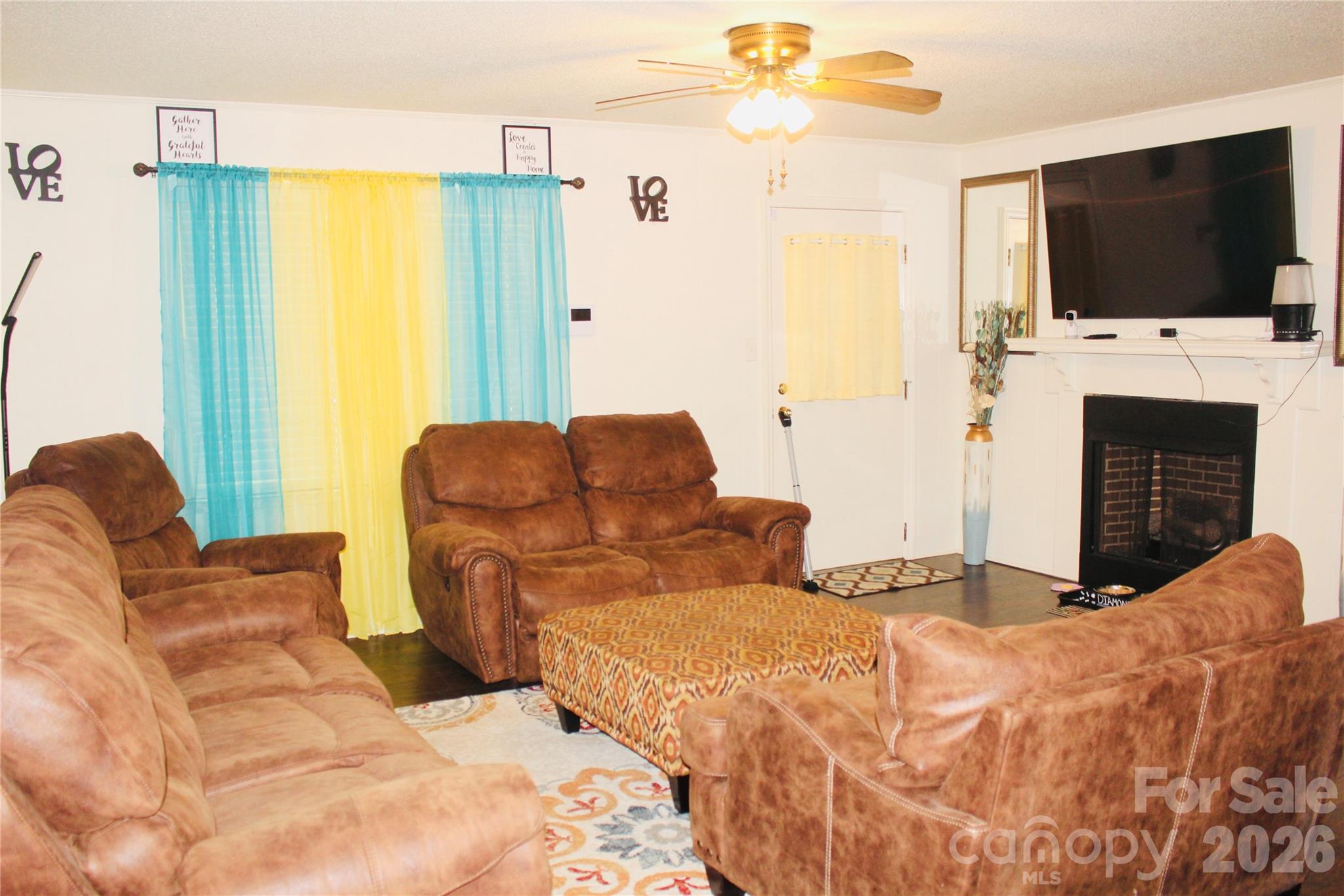 1481 Grace Avenue Lancaster, SC 29720 - Photo 8 of 22 a living room with couches a flat screen tv and a fireplace