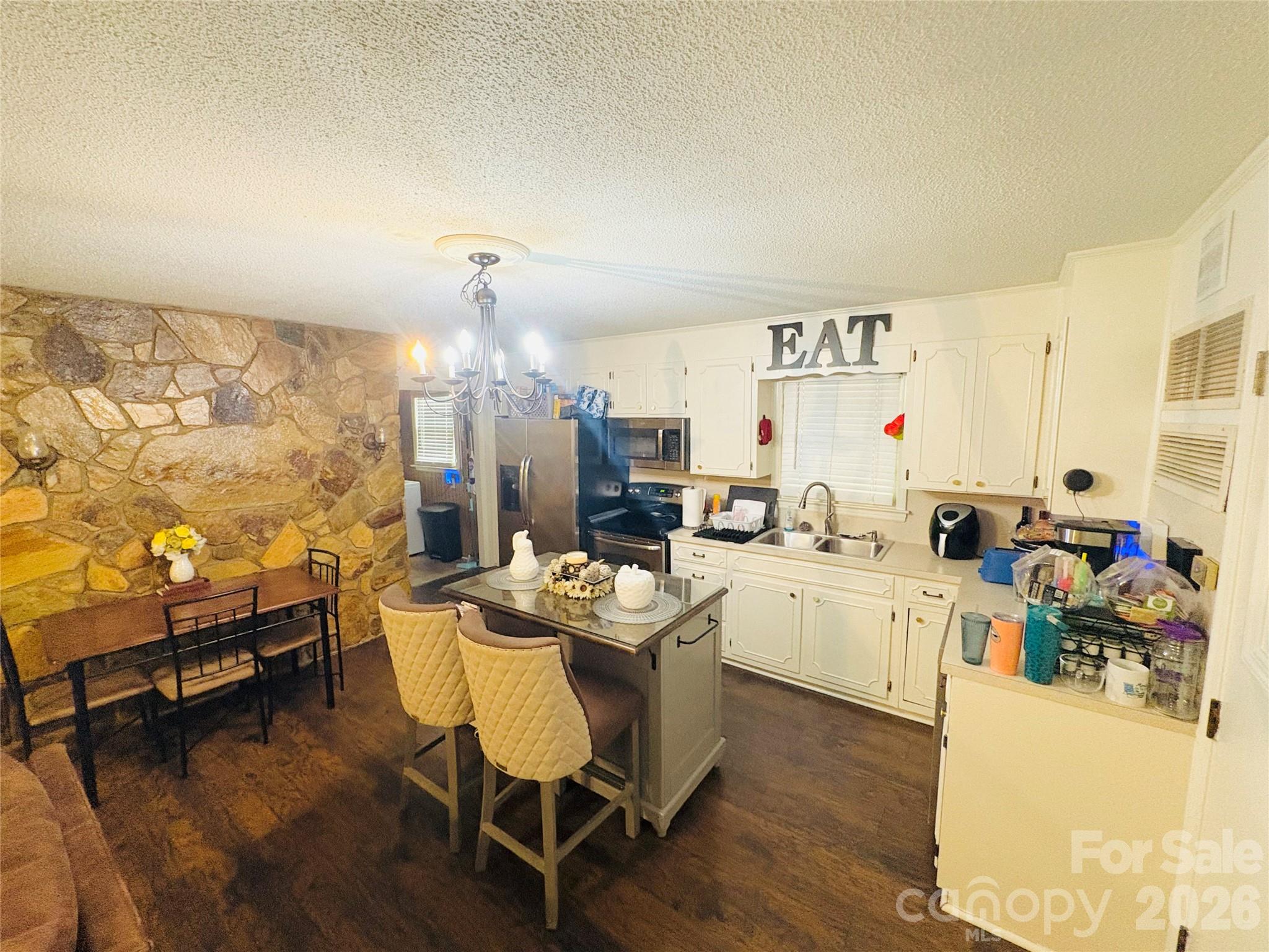 1481 Grace Avenue Lancaster, SC 29720 - Photo 10 of 22 a very nice looking dining room with a large window kitchen island and stainless steel appliances