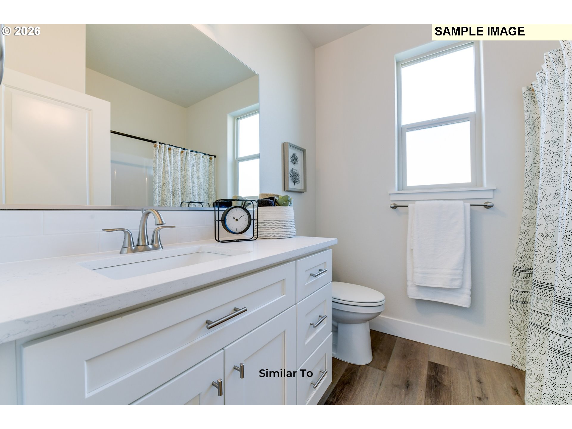 215 Southwest Sparrow Street Boardman, OR 97818 - Photo 13 of 28 a bathroom with a granite countertop sink a toilet a mirror and a window