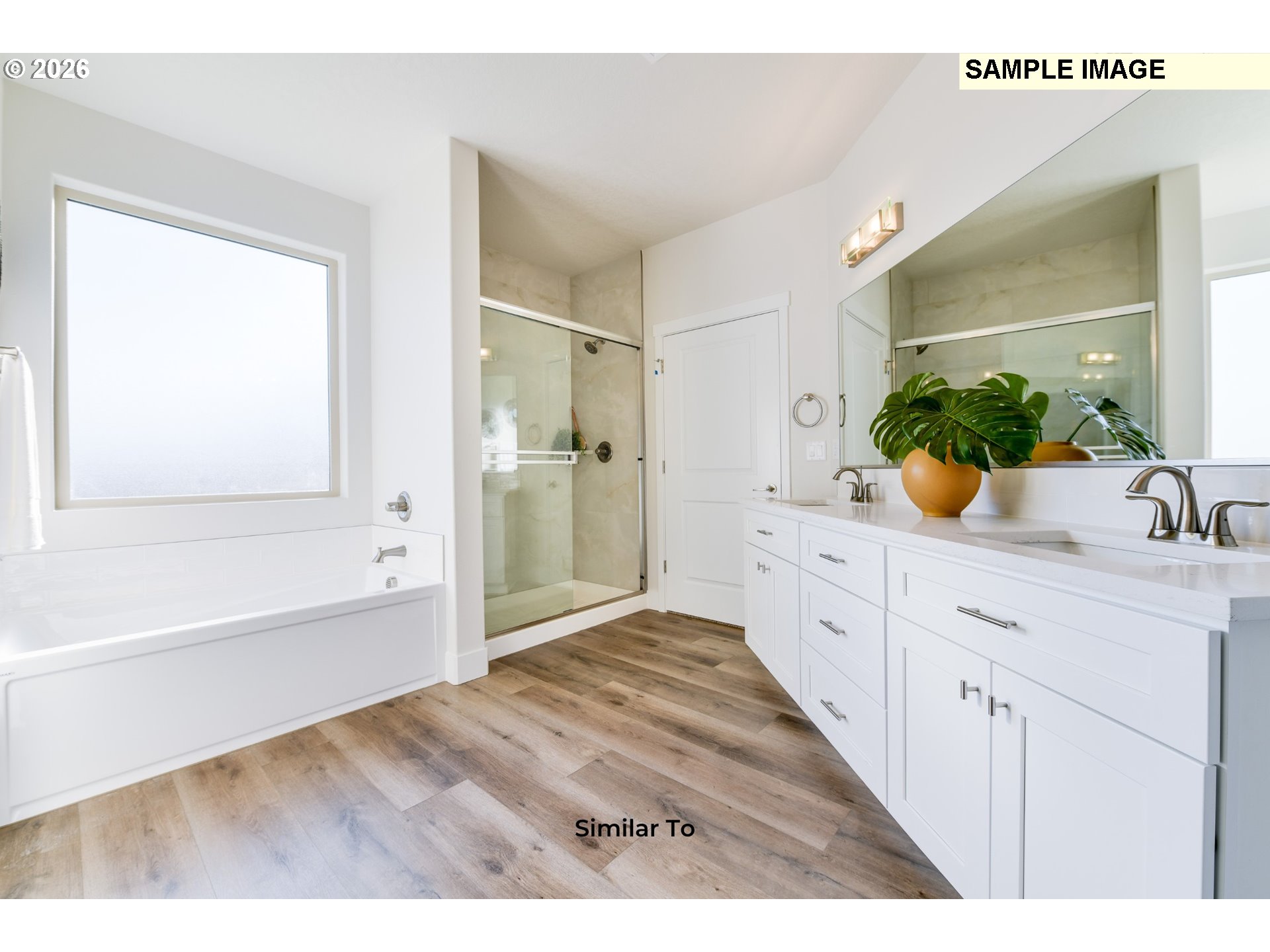215 Southwest Sparrow Street Boardman, OR 97818 - Photo 20 of 28 a spacious bathroom with a granite countertop sink mirror and a bathtub