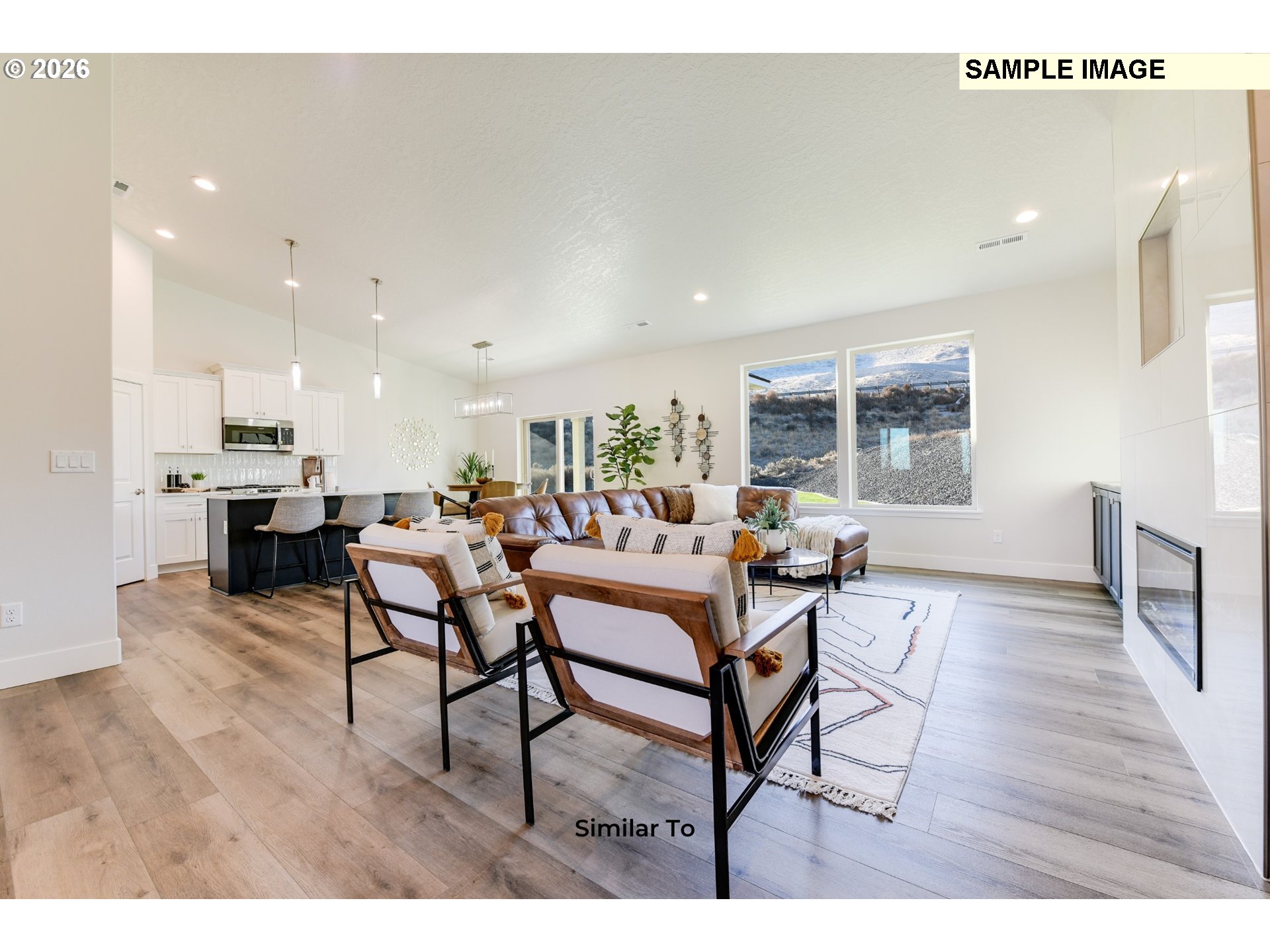 215 Southwest Sparrow Street Boardman, OR 97818 - Photo 23 of 28 a living room with furniture and a dining table with wooden floor